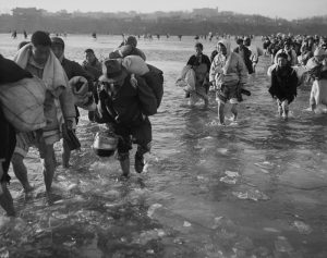 Koreans Fleeing Pyongyang braving the icy waters of the Taedong River. December 10, 1950