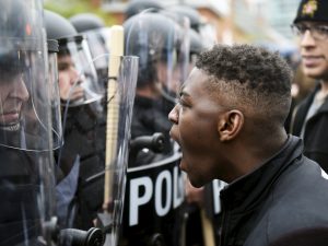 A demonstrator confronts police near Camden Yards during a protest against the death in police custody of Freddie Gray in Baltimore April 25, 2015. At least 2,000 people protesting the unexplained death of Gray, 25, while in police custody marched through downtown Baltimore on Saturday, pausing at one point to confront officers in front of Camden Yards, home of the Orioles baseball team. REUTERS/Sait Serkan Gurbuz