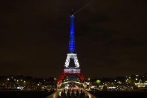 A photo taken on November 16, 2015 in Paris shows the Eiffel Tower illuminated with the colors of the French flag in tribute to the victims of the November 13, 2015 Paris attacks (AFP Photo/Alain Jocard)