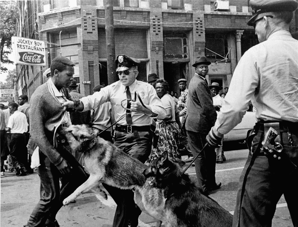 A 17 year old African American civil rights activist is attacked by police dogs during a demonstration in Birmingham, Ala., May 3, 1963. (AP Photo/Bill Hudson)