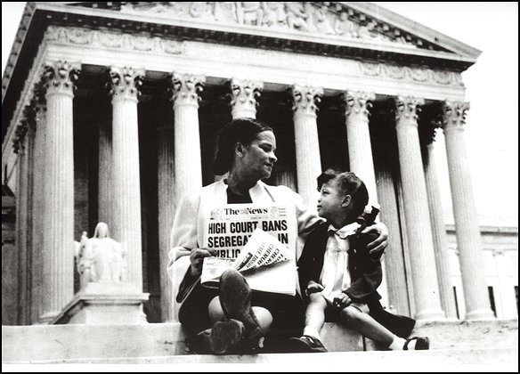 Mrs. Nettie Hunt, sitting on steps of Supreme Court, holding newspaper, explaining to her daughter Nikie the meaning of the Supreme Court's decision banning school segregation.  Courtesy of Library of Congress, Prints and Photographs Division LC-USZ62-127042