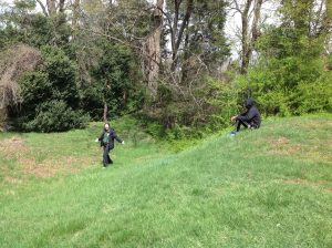 As our guide Dr. Cheryl-Ann Repetti helps us imagine the past, a student sits atop one of the earthen trenches that acted as passageways to keep towns people safe during the Civil War.