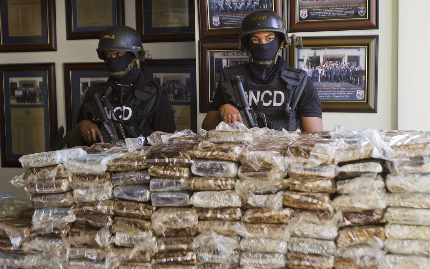 Members of a drug squad guard more than 700 kilos of cocaine divided into 682 packages which were seized during an operation, in Santo Domingo on March 21, 2013.