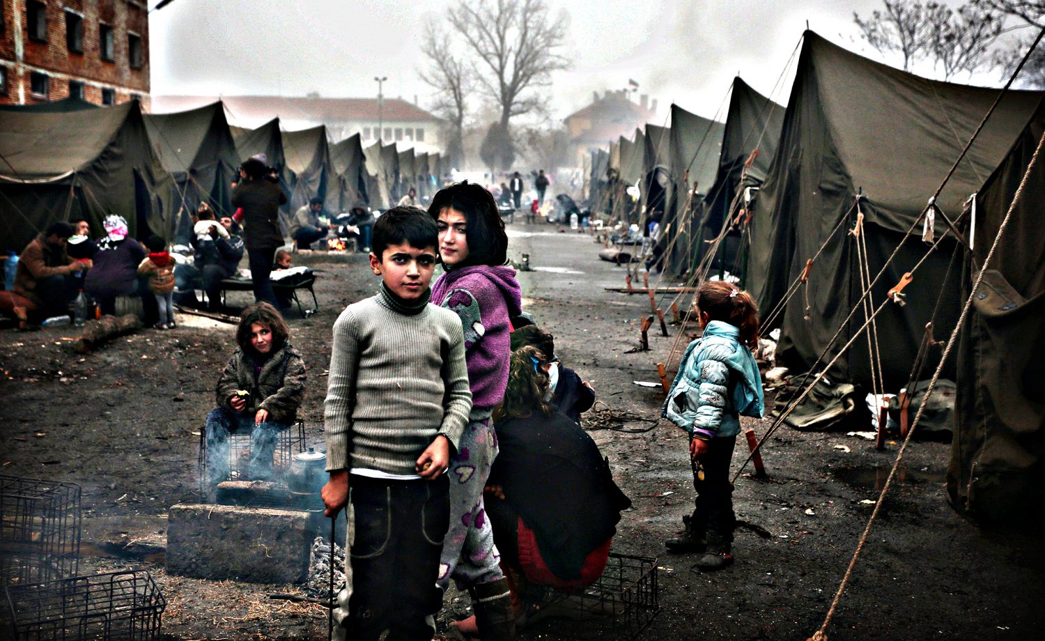 Syrian children try to stay warm near an open fire in front of their unheated tents in a refugee camp in the town of Harmanli, Bulgaria, Thursday, Nov. 21, 2013. Thousands of Syrian and other refugees from the Middle East, Asia and Africa, who find enough courage to make a dangerous journey from their war-ravaged states, often end up in the crammed settlements in the Balkans, including Bulgaria, Greece or Serbia, after being caught on the borders of wealthy Western European nations for attempting to cross illegally. (AP Photo/Valentina Petrova)