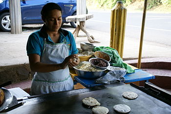 English: Baking pupusas at Las Chinamas in El ...