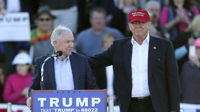 Republican presidential candidate Donald Trump, right, stands next to Sen. Jeff Sessions, R-Ala., as Sessions speaks  during a rally Sunday, Feb. 28, 2016, in Madison, Ala. (AP Photo/John Bazemore)