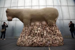 Sculpture by Liu Qiang titled “29h59’59” portrays humans disturbing addiction to milk of a cow, and what the animal has to endure in order to provide everyone with it.