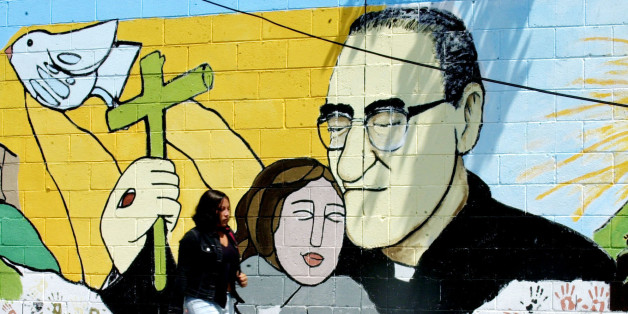 A woman passes a mural of slain Bishop Oscar Arnulfo Romero in Santa Tecla, some 8 miles from San Salvador, Tuesday, March 22, 2005. Salvadorans are commemorating the 25th anniversary of the murder of Bishop Oscar Arnulfo Romero on March 24. (AP Photo/Luis Romero) ** EFE OUT**