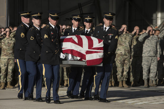 Utah National Guard Honor Guard carry a casket containing the remains of Maj. Brent R. Taylor at the National Guard base Wednesday, Nov. 14, 2018. in Salt Lake City. The remains of a Utah mayor killed while serving in the National Guard in Afghanistan were returned to his home state on Wednesday, Nov. 14, 2018, as hundreds of soldiers saluted while his casket covered in an American flag was carried across a tarmac and into a hearse. (Matt Herp/Standard-Examiner, via, Pool)