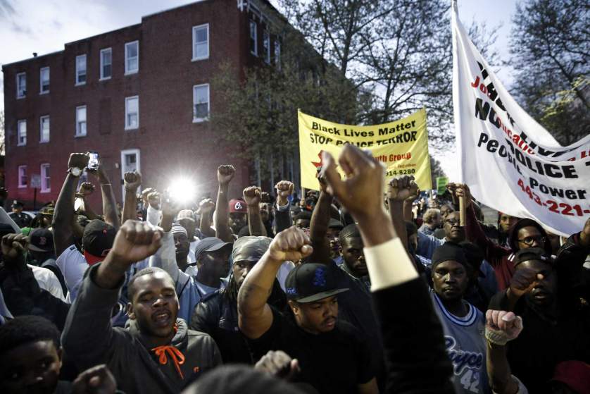 BALTIMORE, MD - ARPIL 21:  Protestors participate in a vigil for Freddie Gray down the street from the Baltimore Police Departments Western District police station, April 21, 2015 in Baltimore, Maryland.  Gray, 25, died from spinal injuries on April 19, one week after being taken into police custody. (Photo by Drew Angerer/Getty Images)