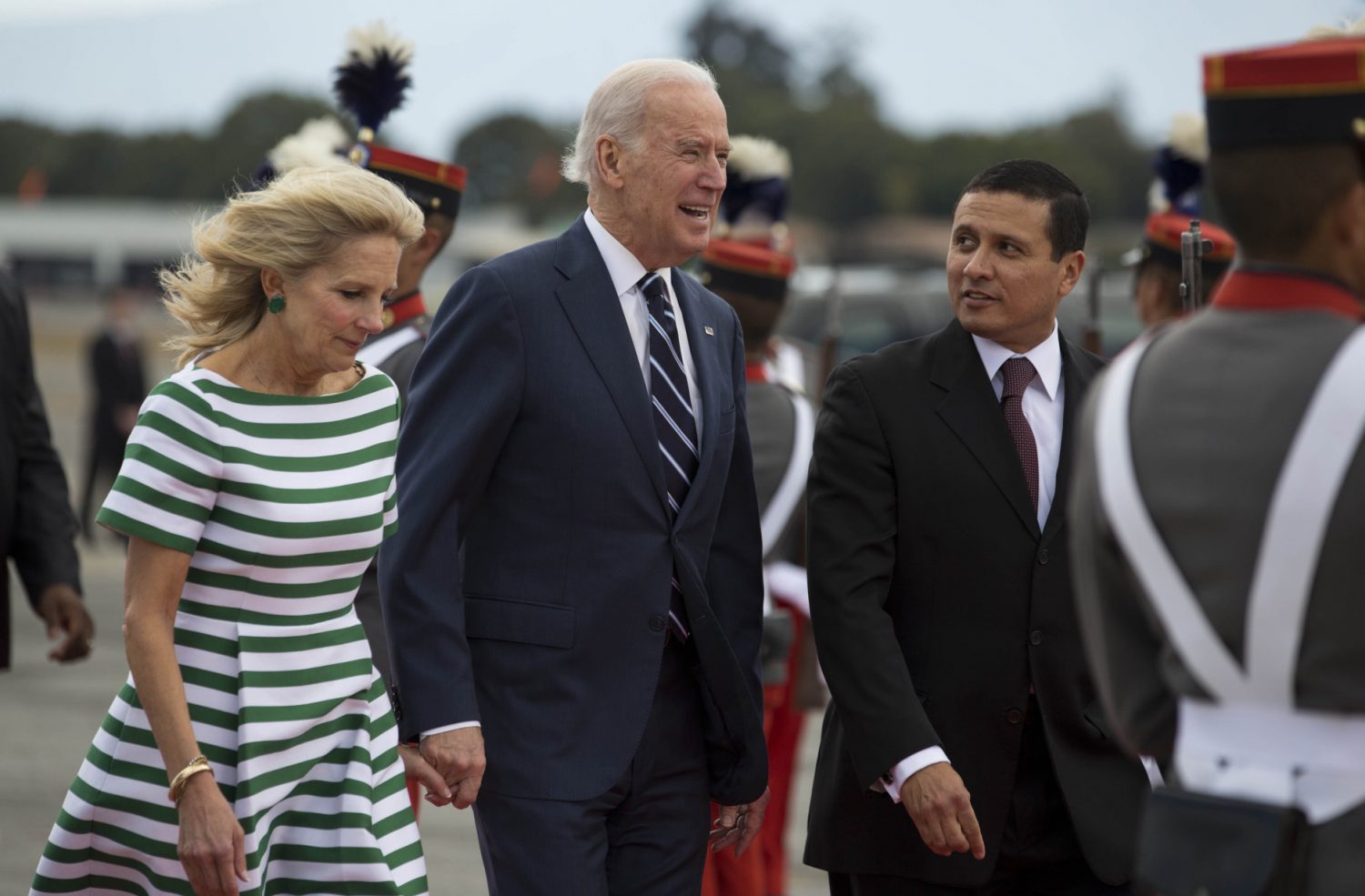 U.S. Vice President Joe Biden, center, and his wife Jill Biden walk with Guatemalan Foreign Minister Carlos Raul Morales after their arrival to an air force base in Guatemala City, Monday, March 2, 2015. Joe Biden is starting a two day trip to meet with the leaders of Guatemala, El Salvador and Honduras regarding immigration issues. (AP Photo/Moises Castillo)